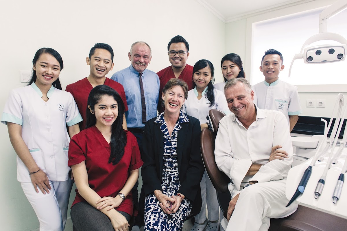 ARC Dental Bali full team and satisfied clients sharing a warm group photo in the clinic