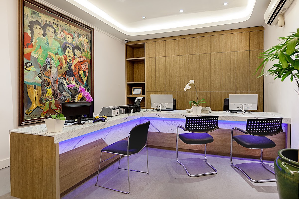 Luxurious reception area at ARC Dental Bali with marble counters, purple LED lighting, and elegant decor
