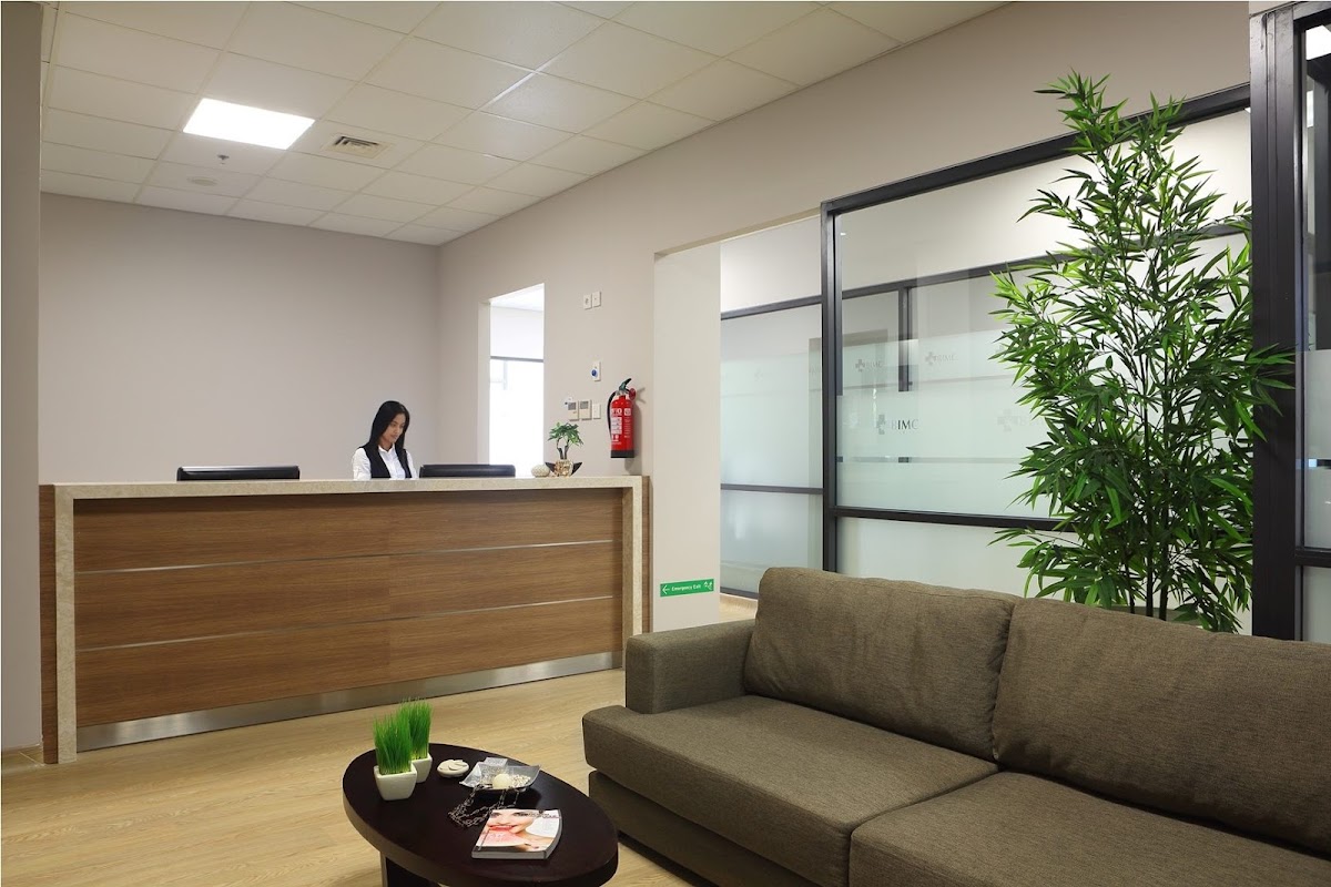 BIMC Hospital Dental Centre secondary waiting area with wooden reception desk and comfortable seating