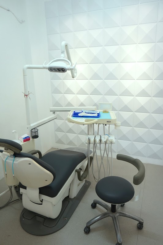 Cosmodent Bali treatment room with dental chair, overhead light, and modern textured wall panels