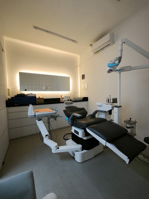 Cosmodent Bali modern treatment room with sleek dental chair and LED-backlit mirror