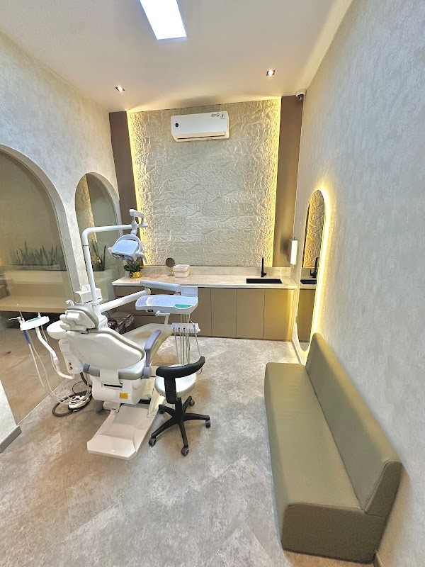 CS Dental Canggu luxurious treatment room with warm accent lighting, arched mirror, and spa-like design