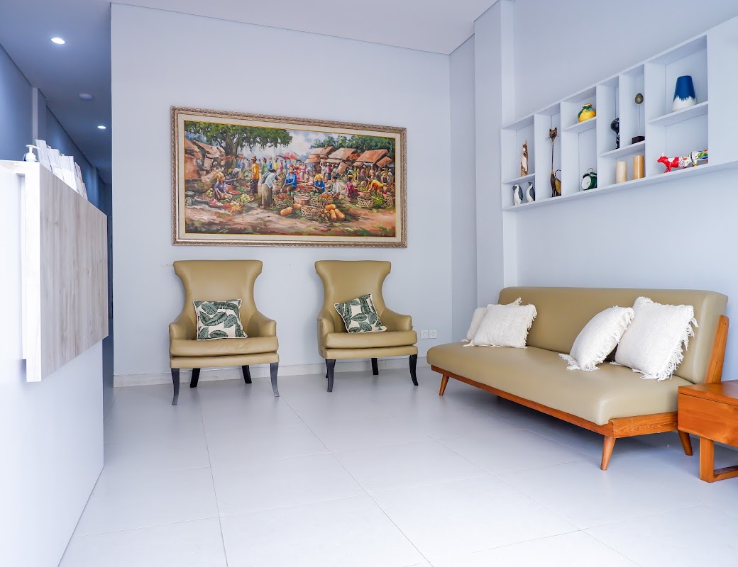 Rejuvie Dental Bali comfortable waiting room with wingback chairs, sofa, and elegant decor
